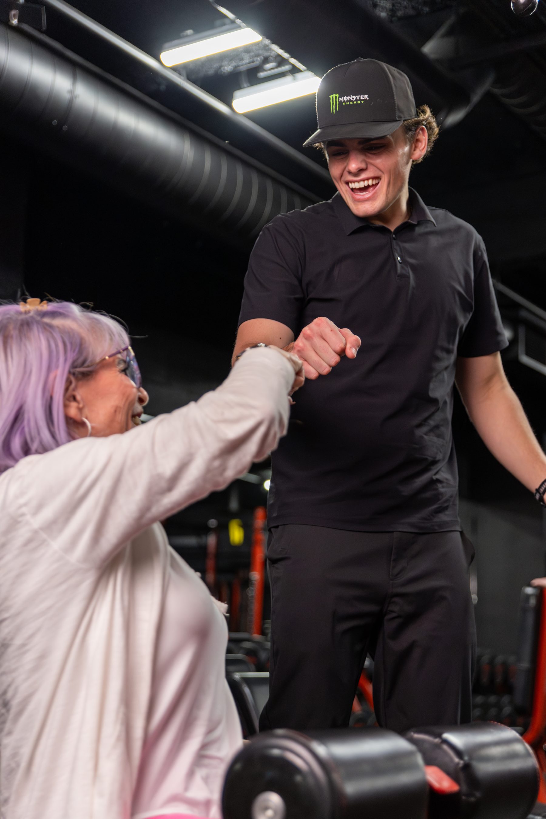 Coach fist-bumping a longtime member at Legacy Del Mar