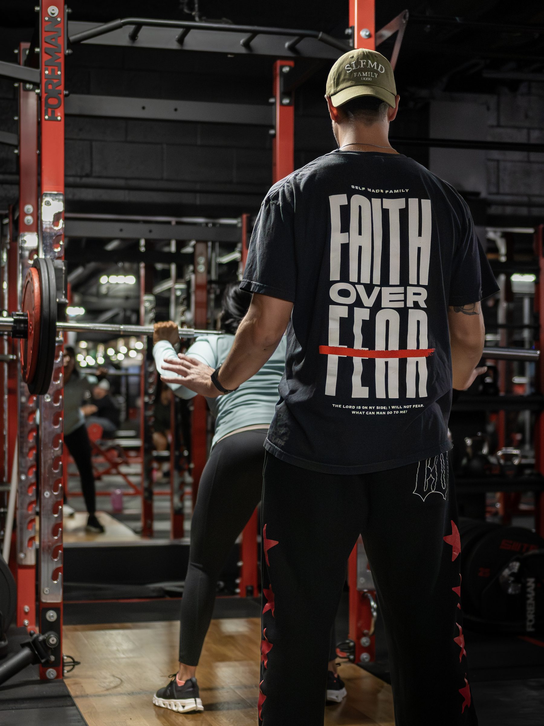 Member in a Faith Over Fear shirt on the Legacy Del Mar floor