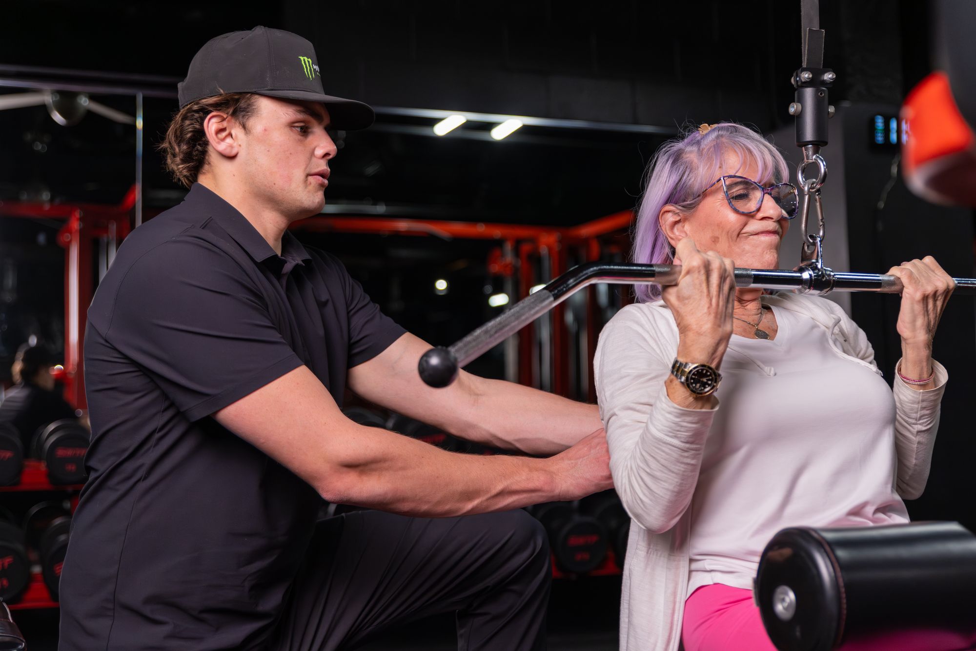 Coach guiding a lat pulldown at Legacy Performance Institute