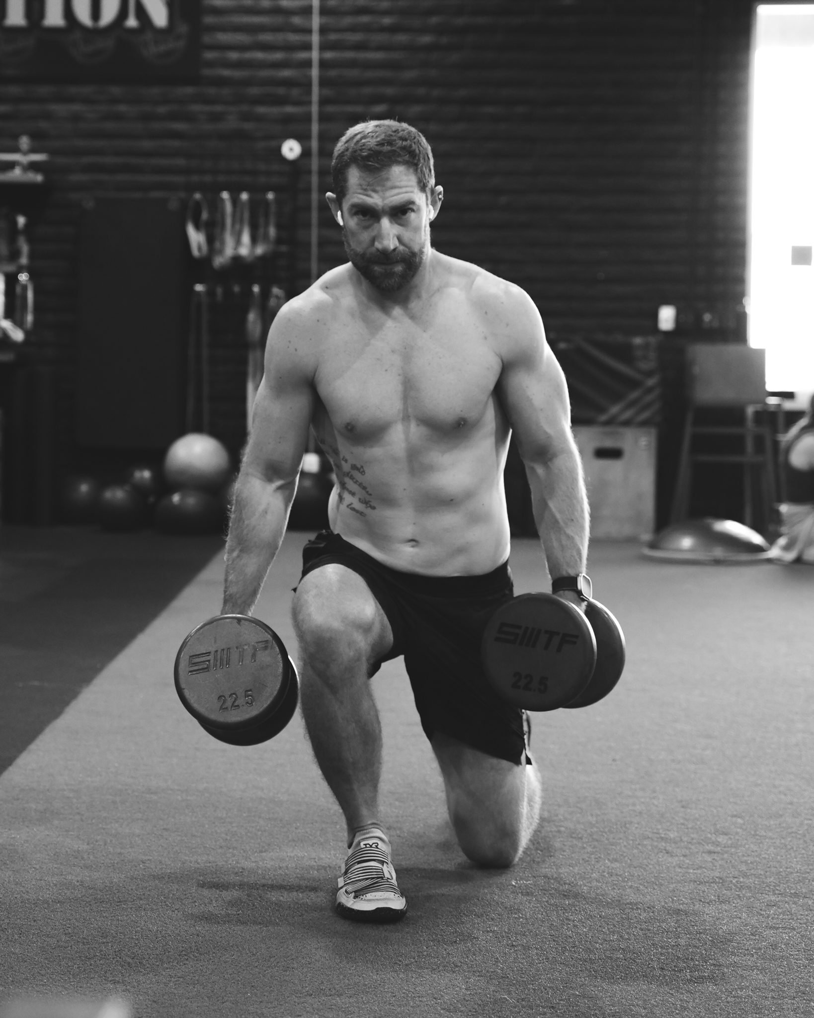 Athlete in a dumbbell split squat at Legacy San Diego