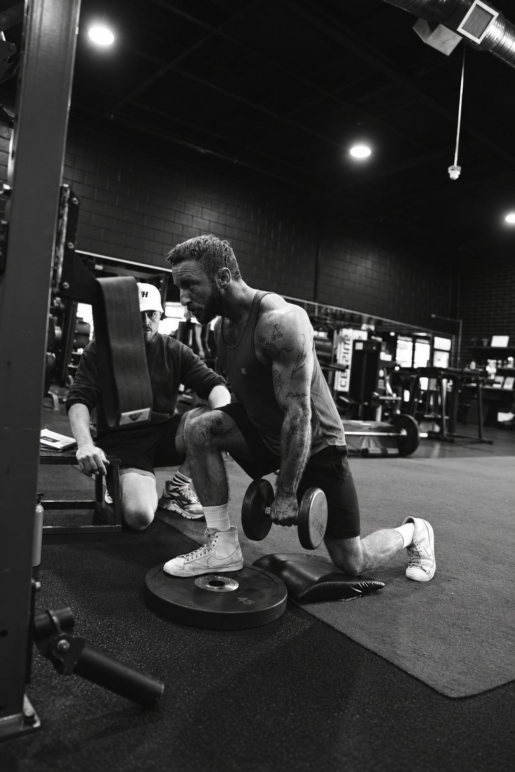 Weighted lunge on the Legacy San Diego strength floor